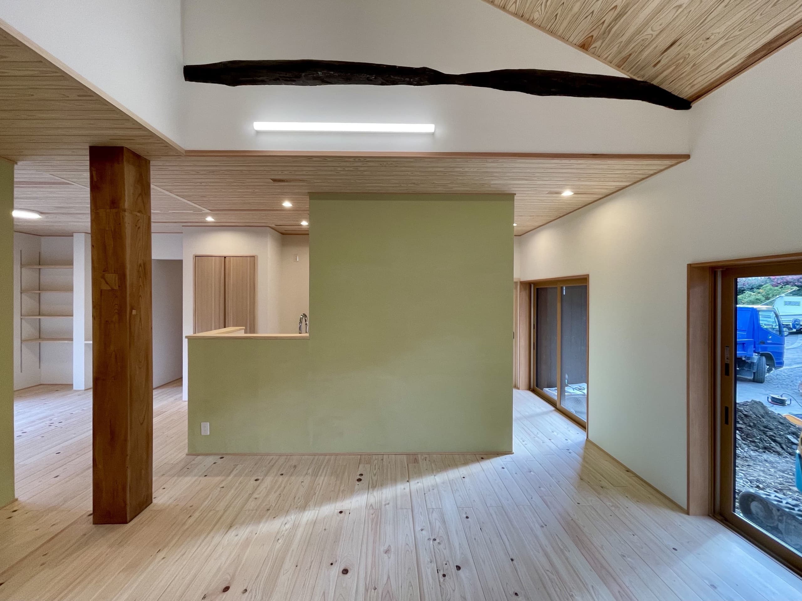 古い梁がアクセントになった、木の温もりが感じられるリビング